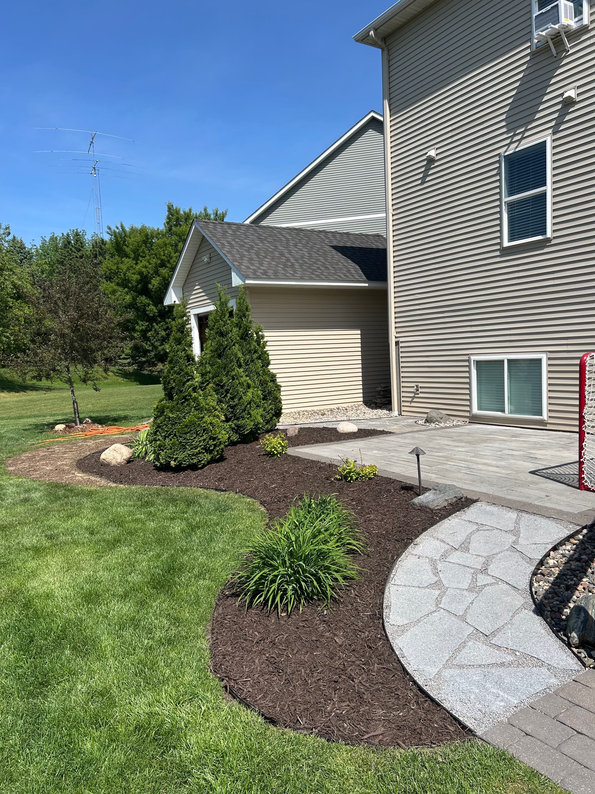 Granite Flagstone Walkway and Landscaping Refresh with Dark Mulch image